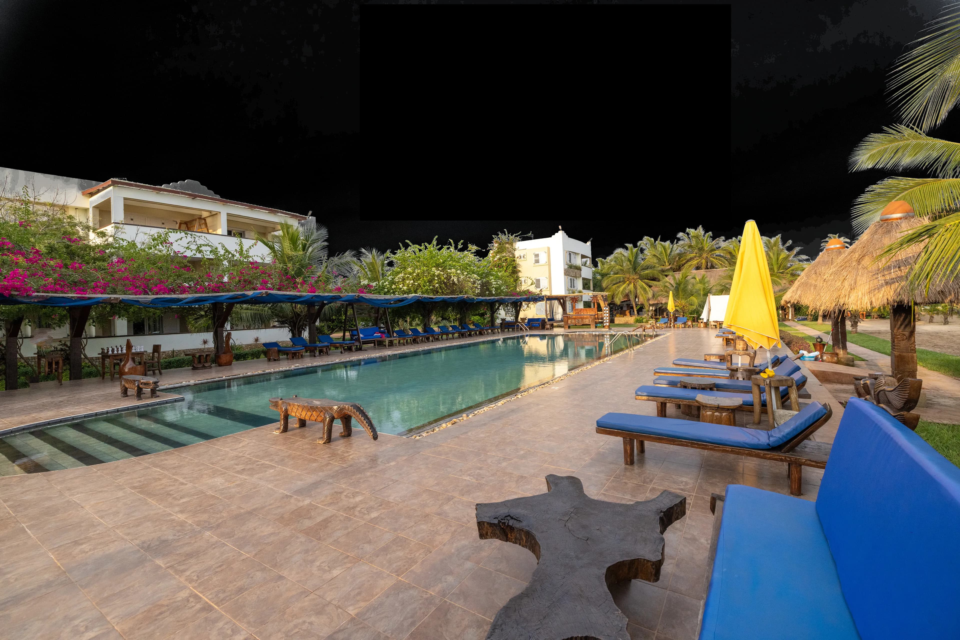The grounds from above, the pool and the beach running along the foot of the property
