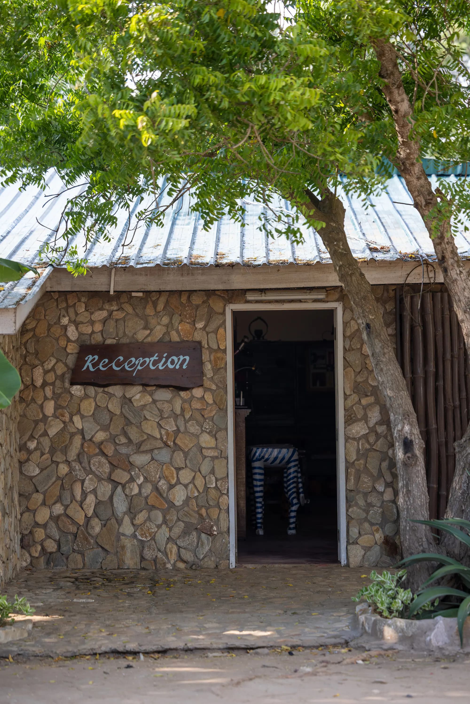 The stone reception building under the trees